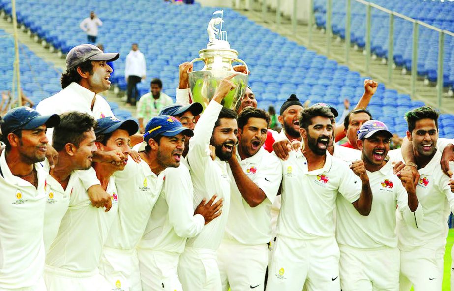 The Mumbai players celebrate their 41st Ranji Trophy title at Pune in India on Friday.