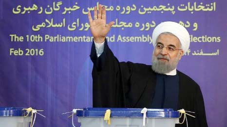 Iranian President Hassan Rouhani waves after casting his vote during elections for the parliament and Assembly of Experts, which has the power to appoint and dismiss the supreme leader in Tehran.