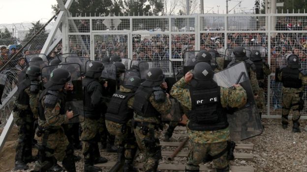 Macedonian police confronted hundreds of angry migrants at the fence