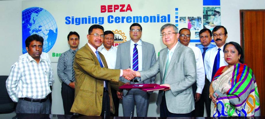 Abdul Halim Molla, Member (Investment Promotion) of BEPZA and Do Kyun Kim, Managing Director of Ms CS Bangla limited sign an agreement at BEPZA Complex on Monday for investment of US$ 25 million to establish a tent & outdoor camping items manufacturing i