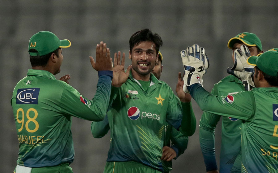 Mohammad Amir is congratulated after knocking over Muhammad Kaleem's off stump during the Asia Cup Cricket match between Pakistan and UAE at the Mirpur Sher-e-Bangla National Cricket Stadium on Monday.