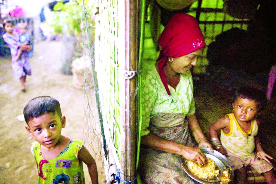 Rohingya family members gather at their shelter at the Thel-Chaung displacement camp in Sittwe located in Rakhine State .