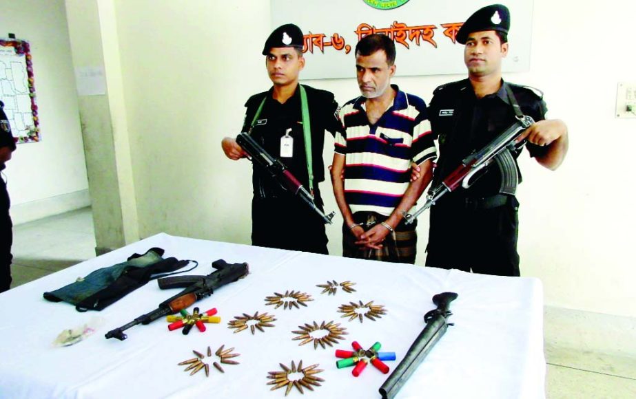 JHENAIDAH: Arrested Badsha Lasskar with arms and ammunitions with RAB men in Jhenaidah on Tuesday.