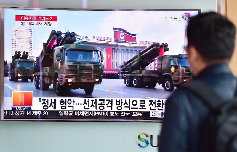 People in Seoul watch a news report on Friday showing file footage of North Korean missiles on parade.