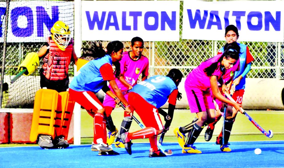 A scene from the match of the Walton 3rd National Women's Hockey Competition between Narail District team and Rajshahi District team at the Moulana Bhashani National Hockey Stadium on Friday.