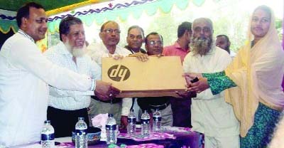 SAGHATA (Gaibandha): Deputy Speaker of the National Parliament Adv Fazley Rabbi Mia MP distributing ICT materials at ICS Club as Chief Guest at Thoikrerpara on Friday.