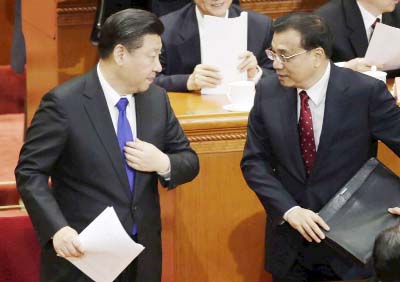 China's President Xi Jinping (L) and Premier Li Keqiang talk as they prepare to leave the opening session of the Chinese People's Political Consultative Conference (CPPCC) at the Great Hall of the People in Beijing, China.