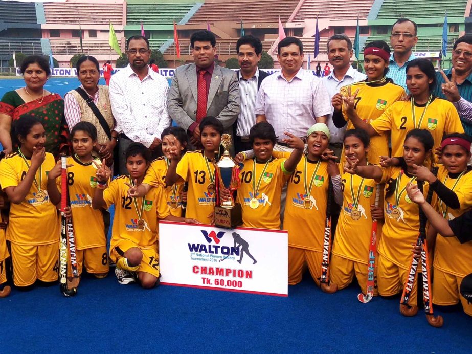 Members of Jhenaidah District team, the champions of the Walton 3rd National Women's Hockey Competition and the guests and the officials of Bangladesh Hockey Federation pose for a photo session at the Moulana Bhashani National Hockey Stadium on Sunday.