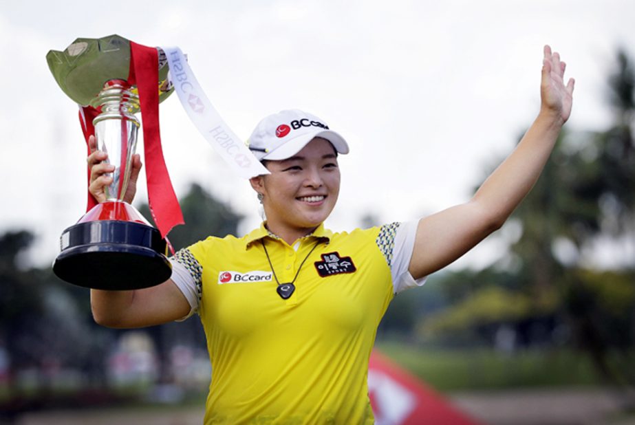 Jang Ha Na of South Korea celebrates with her trophy after winning the HSBC Women's Champions Golf tournament on Sunday in Singapore.