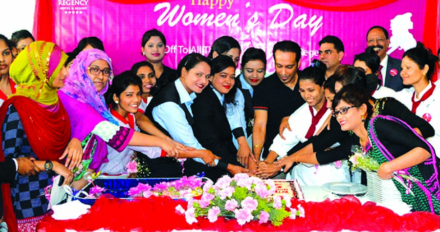 Owners of Dhaka Regency Hotel cutting a cake with its staffs to celebrate International Womenâ€™s Day at the hotel in the city on March 8.