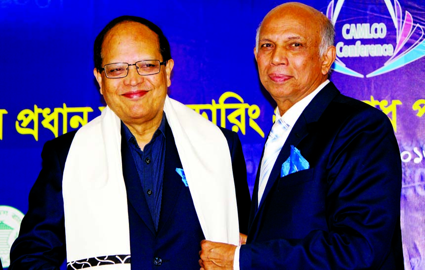 Aminul Islam, Managing Director (CC) of Bank Asia, presenting 'Uttario" to Dr Atiur Rahman, Governor of Bangladesh Bank at the closing ceremony of CAMLCO Conference'2016 at Habigonj recently.