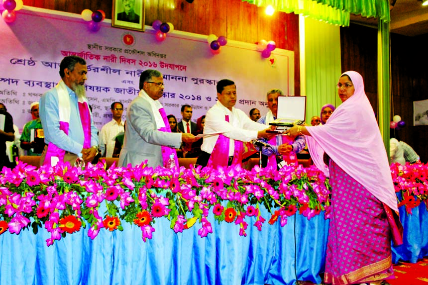 Secretary of the Local Government Division Abdul Malek distributing citation to the best self-reliance women under LGED in the auditorium of LGED in the city's Agargaon on Tuesday marking International Women's Day.