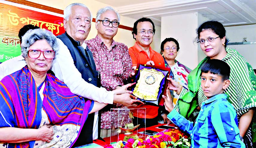 Presidium Member of Bangladesh Awami League Satish Chandra Roy handing over Mother Teresa Gold Medal-2016 to Managing Director of Rifat Enterprise Kazi Munni as a successful women entrepreneur in agriculture at a ceremony organized recently by Mother Tere