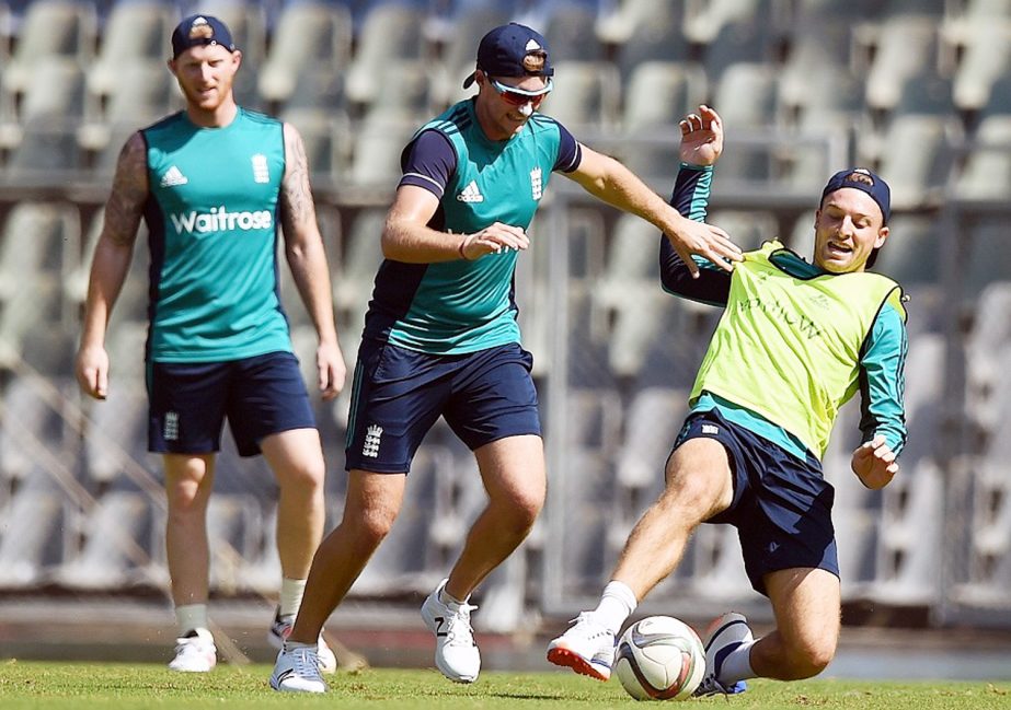 England cricket player Jos Buttler (R) plays football with teammates during a training session at Wankhede Stadium in Mumbai on March 10, 2016. England plays their first match in the World T20 cricket tournament against the West Indies on March 16 in Mumb