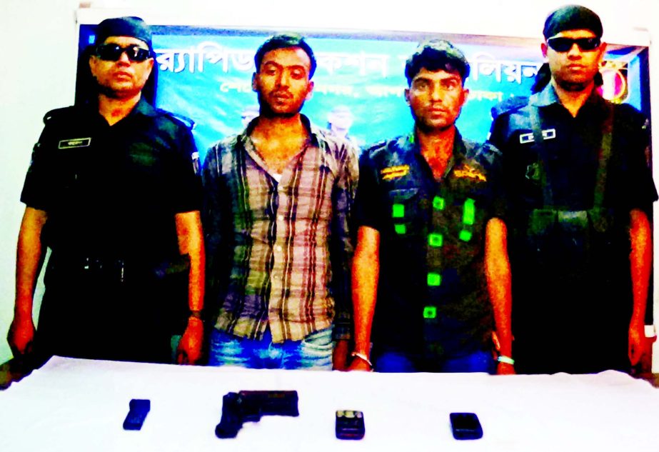 RAB members nabbed two arms traders with foreign made pistol, magazine and mobile set from Dwin KG School intersection in the city's Mirpur on Friday.