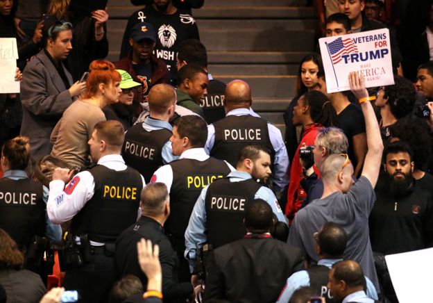 Early protesters were escorted out, before the rally descended into chaos