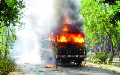 NAOGAON: Angry people blockaded Dhamirhat- Joypurhat Highway in Chakmoyram area and set fire on two trucks following death of a school boy Shadhin yesterday.