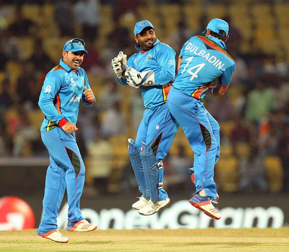 Afghanistan cricketers Shahzad Mohammadi (C) and Gulabdin Naib (R) celebrate after winning their T20 World Cup cricket match against Zimbabwe at the VCA stadium in Nagpur on Saturday.