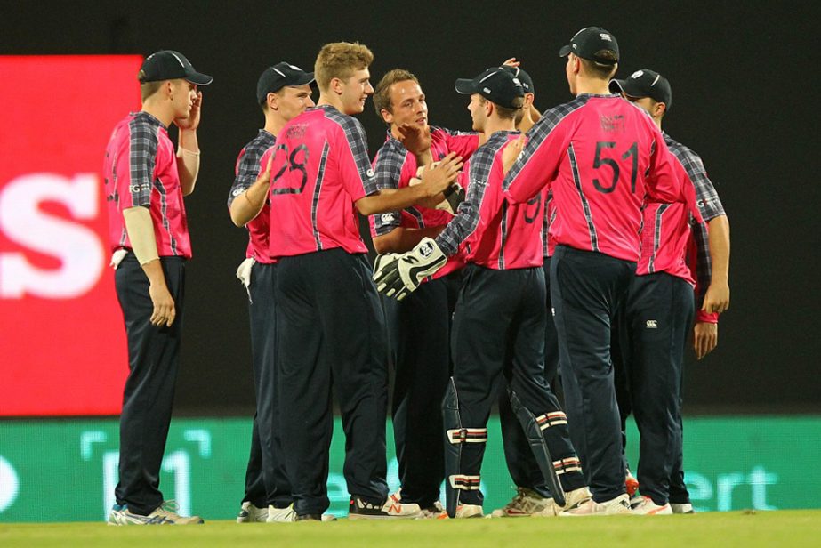 Gavin Main (3-L) of Scotland celebrates wicket of Ryan Campbell of Hong Kong during the T20 World Cup cricket match between Scotland and Hong Kong at the VCA stadium in Nagpur on Saturday.