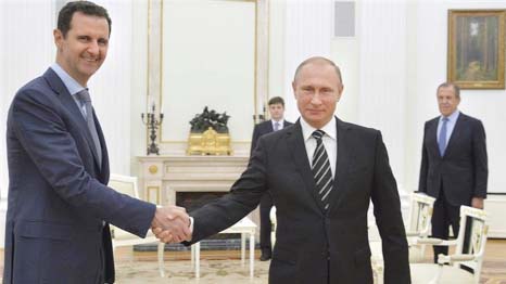 Syria's President Bashar al-Assad shaking hands with Russian president Vladimir Putin at Kremlin.