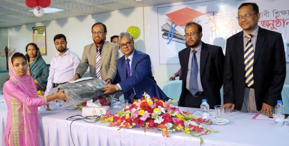 Mijanur Rahman Joddar, Executive Director, Bangladesh Bank, Chittagong handing over the scholarship money and educational instruments to the students at a function in Chittagong recently as Chief Guest.
