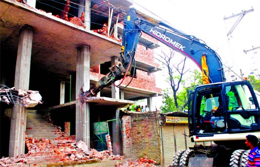 Rajuk authority demolishing a building illegally constructed in city's Keraniganj area on Sunday.