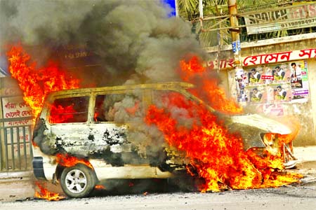 A microbus catches fire as its cylinder exploded in front of Science Laboratory in city on Monday.