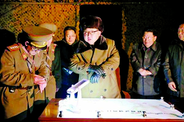 North Korean leader Kim Jong Un talks with officials at the ballistic rocket launch drill of the Strategic Force of the Korean People's Army (KPA) at an unknown location.