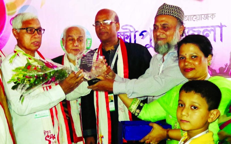 President of Lakshmipur Zilla Samity, Dhaka Farid Ahmed Bhuiyan being awarded by General Secretary of 'Ma Sapna Foundation' Md Saifullah for his contribution in social services at a ceremony organised in the city recently. Gusi Peace Prize International