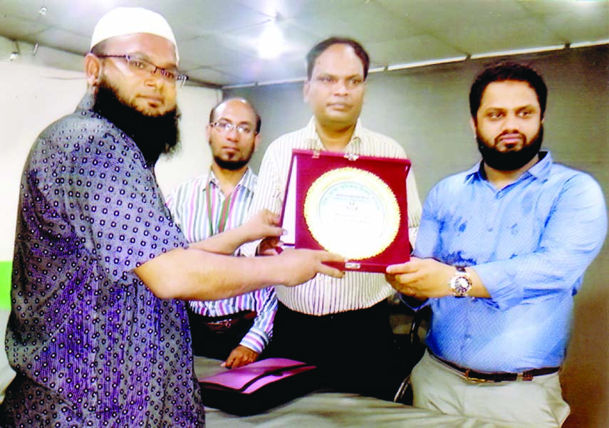 Executive Director of Bangladesh Consumer Rights Society Mahabur Alam Sheikh Russel handing over citation award to Director of Ain Sahayata Kendra Mosharraf Hossain Raju in the auditorium of Bangladesh Shishu Kalyan Parishad in the city on Tuesday marking