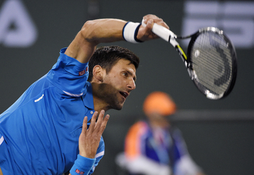 Novak Djokovic of Serbia serves to Philipp Kohlschreiber of Germany at the BNP Paribas Open tennis tournament in Indian Wells, Calif on Tuesday.