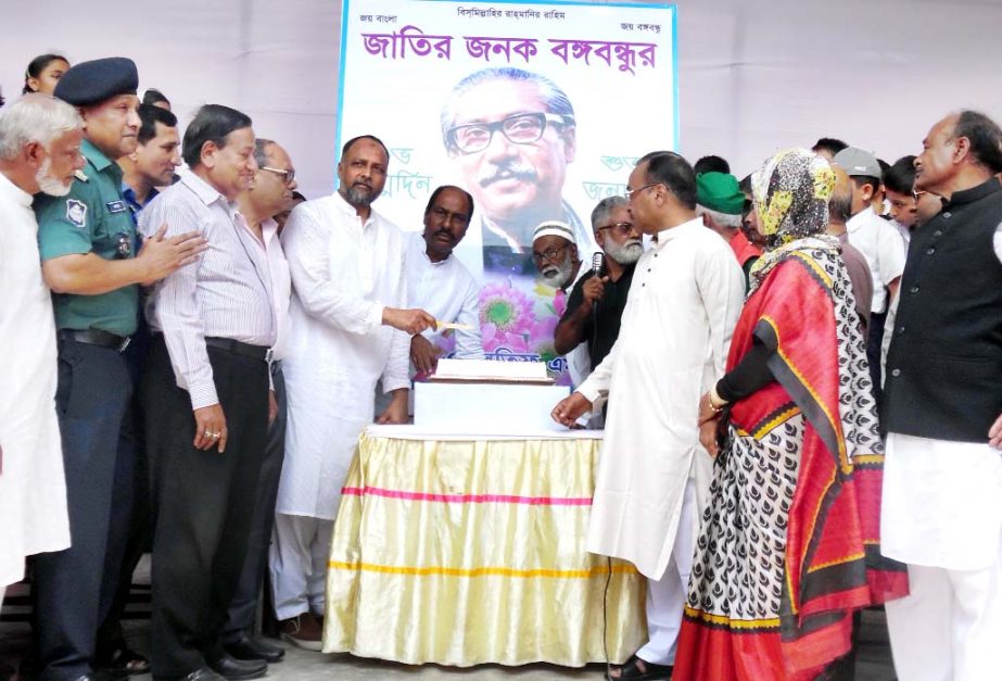 MA Latif MP cutting cake on the occasion of 96th birth anniversary of Bangabandhu Sheikh Mujibur Rahman at Halishahar Begumjan High School yesterday.