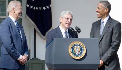 President Barack Obama and Vice President Joe Biden look on as Merrick Garland, Obama's nominee for the Supreme Court vacancy, speaks during his Rose Garden announcement ceremony, at the White House in Washington.