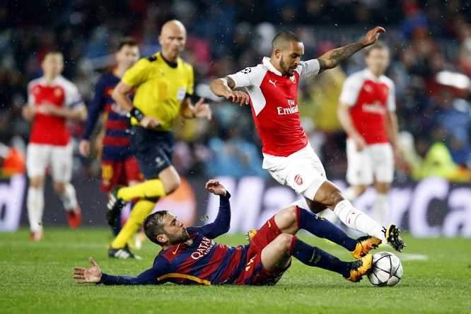 Barcelona's Jordi Alba (left) and Arsenal's Theo Walcott (right) challenge for the ball during the Champions League round of 16 second leg soccer match between FC Barcelona and Arsenal FC at the Camp Nou Stadium in Barcelona, Spain on Wednesday.