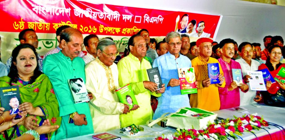 BNP Acting Secretary General Mirza Fakhrul Islam Alamgir, among others, holds the copies of souvenirs published by different sub-committee of the party at the office of Adarsha Dhaka Andolon in the city's Purana Palton on Friday on the occasion of BNP's