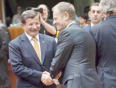 Turkey's Prime Minister Ahmet Davutoglu (L) talks with EU Council President Donald Tusk during the EU summit at headquarters in Brussels on Friday.