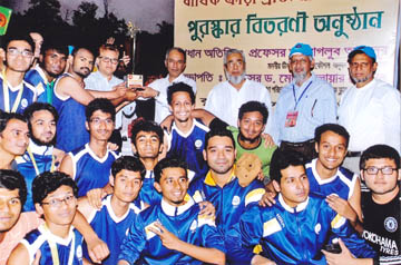 Acting Vice-Chancellor of BUET and Dean of Faculty of Mechanical Engineering Professor Dr Maglub Ali Nur handing over championship trophy of BUET Annual Athletic Competition to the team leader of Titumir Hall at the University Playground on Friday. Profes