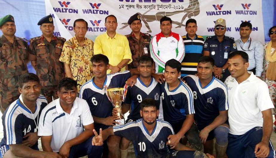 Members of Bangladesh Navy team, the champions of the Walton 3rd Men's Beach Kabaddi Federation with the officials and the guests of Bangladesh Kabaddi Federation pose for a photograph at the Laboni Point in Cox's Bazar Sea Beach on Sunday.