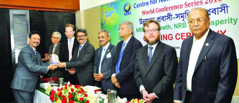 Md Shahriar Alam MP, State Minister for Foreign Affairs on behalf of Centre for NRBs handing over the award to A S M Bulbul, Deputy Managing Director of National Bank Limited at a local hotel in the city. The bank received the award as top ten remittance