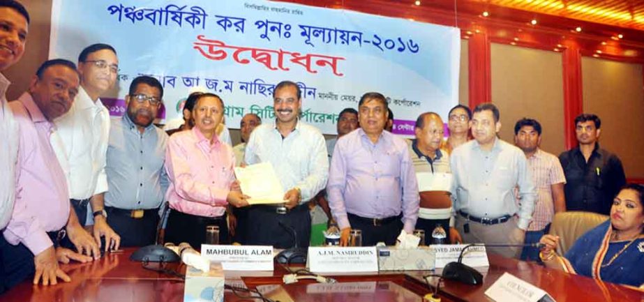 CCC Mayor A J M Nasir Uddin handing over tax evaluation form to Mahbubul Alam, President, Chittagong Chamber of Commerce and Industry at the inaugural programme of tax re-evaluation plan at World Trade Centre on Monday.