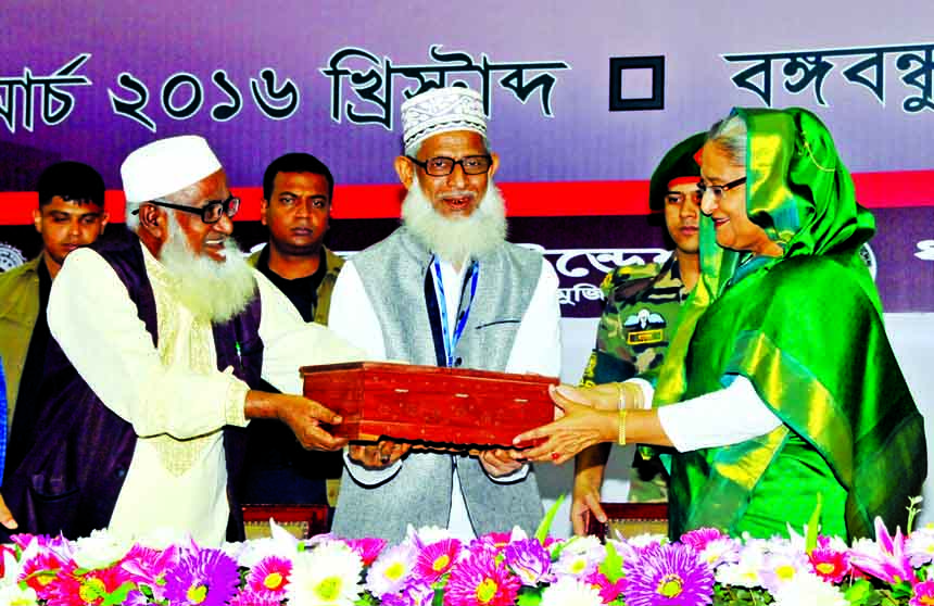 Religious Affairs Minister Principal Matior Rahman and DG of Islamic Foundation Shamim Mohammad Afzal presenting the holy Qur'an to Prime Minister Sheikh Hasina at a ceremony in observance of 41st founding anniversary of Islamic Foundation at Bangabandhu