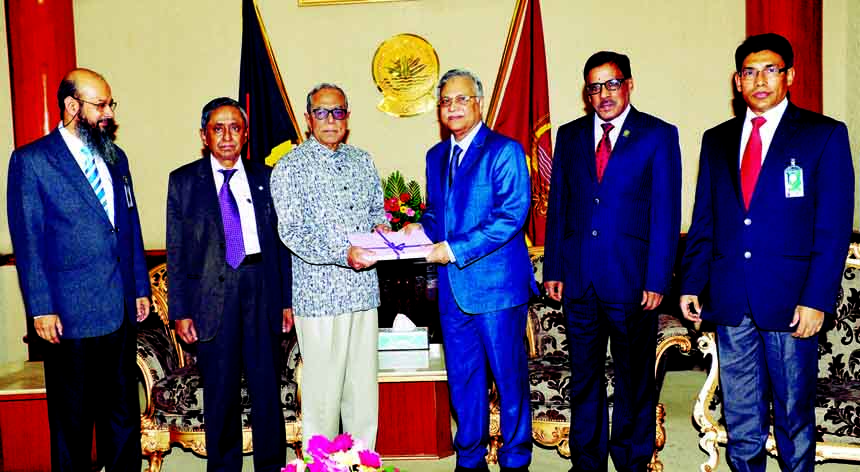 Chairman of Law Commission Justice ABM Khairul Haque submitting annual report of Law Commission-2015 to President Abdul Hamid at Bangabhaban on Tuesday. Photo: Press Wing , Bangabhaban
