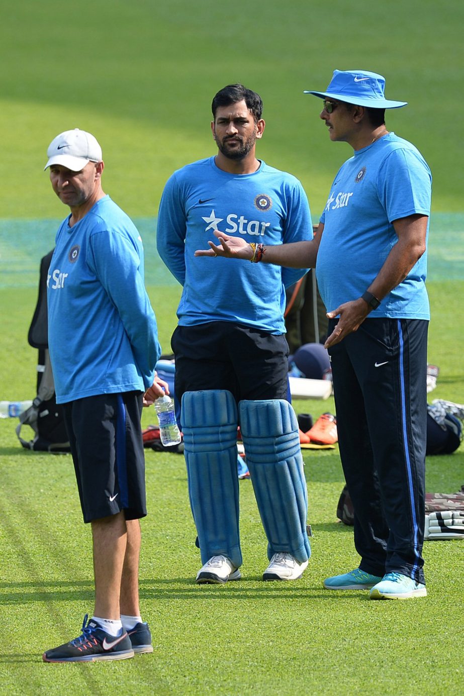 Indian cricket team captain MS Dhoni (C) listens to the team director Ravi Shastri (R) during a practice session on the eve of their match against Bangladesh at The Chinnaswamy Stadium in Bangalore on Tuesday.