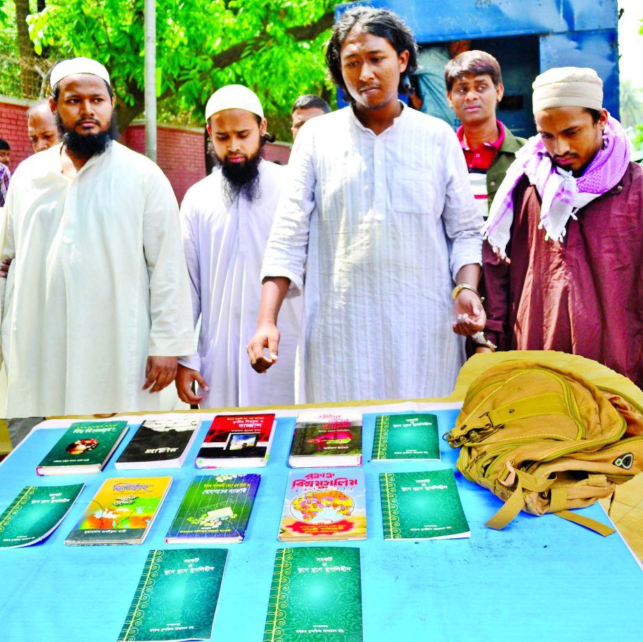 Four suspected militants were arrested with huge religious books from city's Kallyanpur Bus Stand area by DB Police on Monday night.