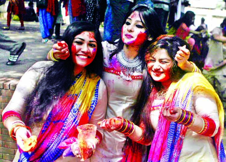 A section of students anoint 'Abir' with one another at the Institute of Fine Arts of Dhaka University on Wednesday marking Dol Purnima, a religious festival of Hindu community.