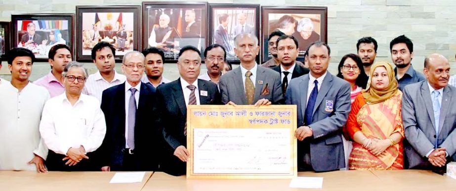 Chairman of Imran Group Lion Md. Jonab Ali hands over a cheque for Tk 10 lakh to Dhaka University Treasurer Prof Dr Md. Kamal Uddin on Tuesday at the Vice-Chancellor's office to introduce the gold medal. Vice-Chancellor of the University Prof Dr AAMS Are