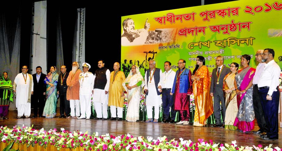 Prime Minister Sheikh Hasina poses with the recipients of Swadhinata Padak '16 after handing over at the Osmani Memorial Auditorium in city on Thursday.