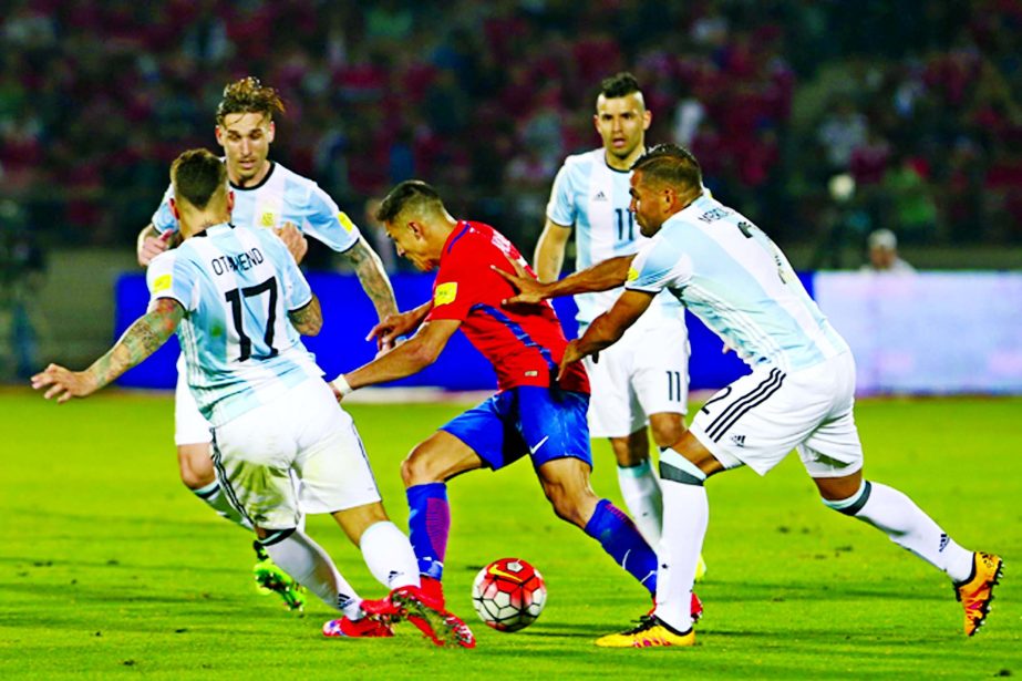 Chile's Alexis Sanchez (center) is surrounded by Nicolas Otamendi (17), Lucas Biglia (back left) Gabriel Mercado (right) and Sergio Aguero (back right) during a 2018 Russia World Cup qualifying soccer match at the National Stadium in Santiago, Chile onTh