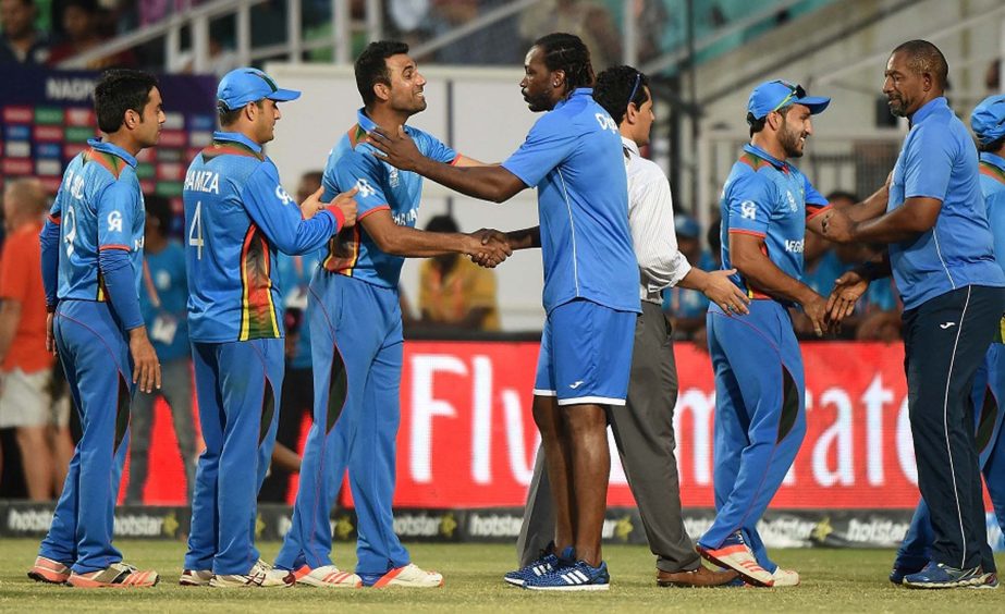 West Indies player Chris Gayle(C) greets Afghanistan's players after Afghanistan won the World T20 cricket tournament match against West Indies at the Vidarbha Cricket Association Stadium in Nagpur on Sunday.