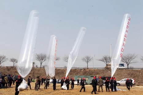 South Korean conservative activists launch large balloons carrying anti-Pyongyang leaflets towards North Korea across the Demilitarised zone in Paju.